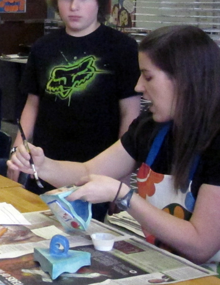 Mrs. Gilroy demonstrating how to watercolor the time capsules